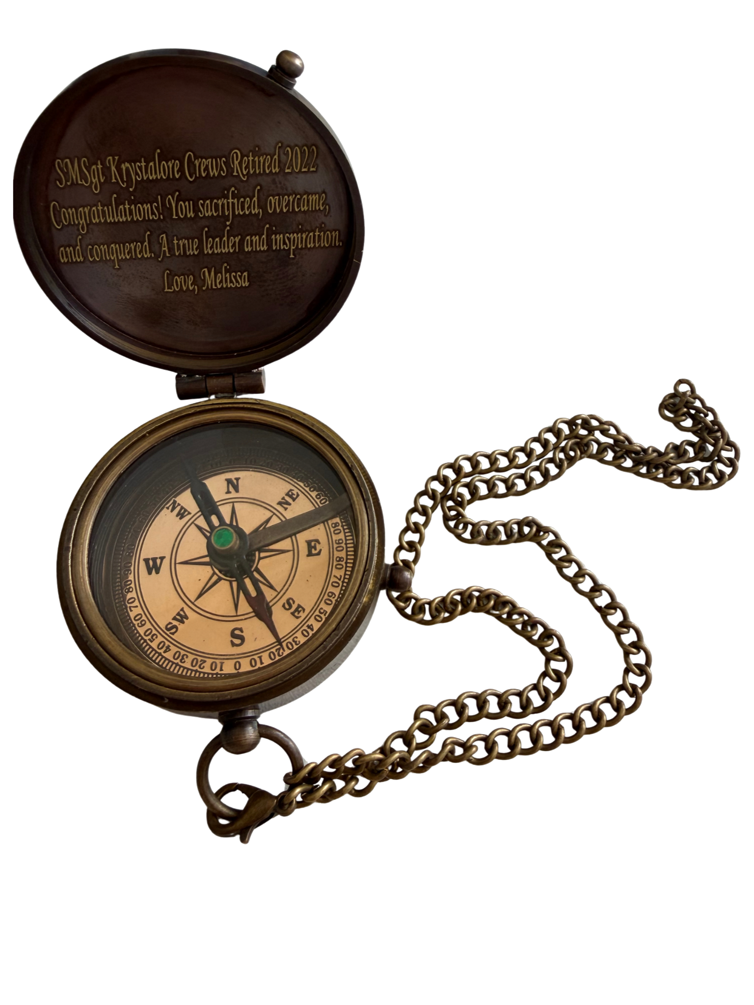 Brass compass given to SMSgt Krystalore Crews on her retirement in 2024